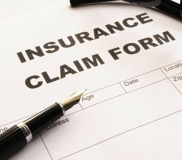 Insurance claim form with fine point pen on paper